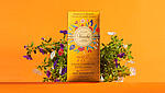 Gold refined Venchi chocolate wrapper against orange background