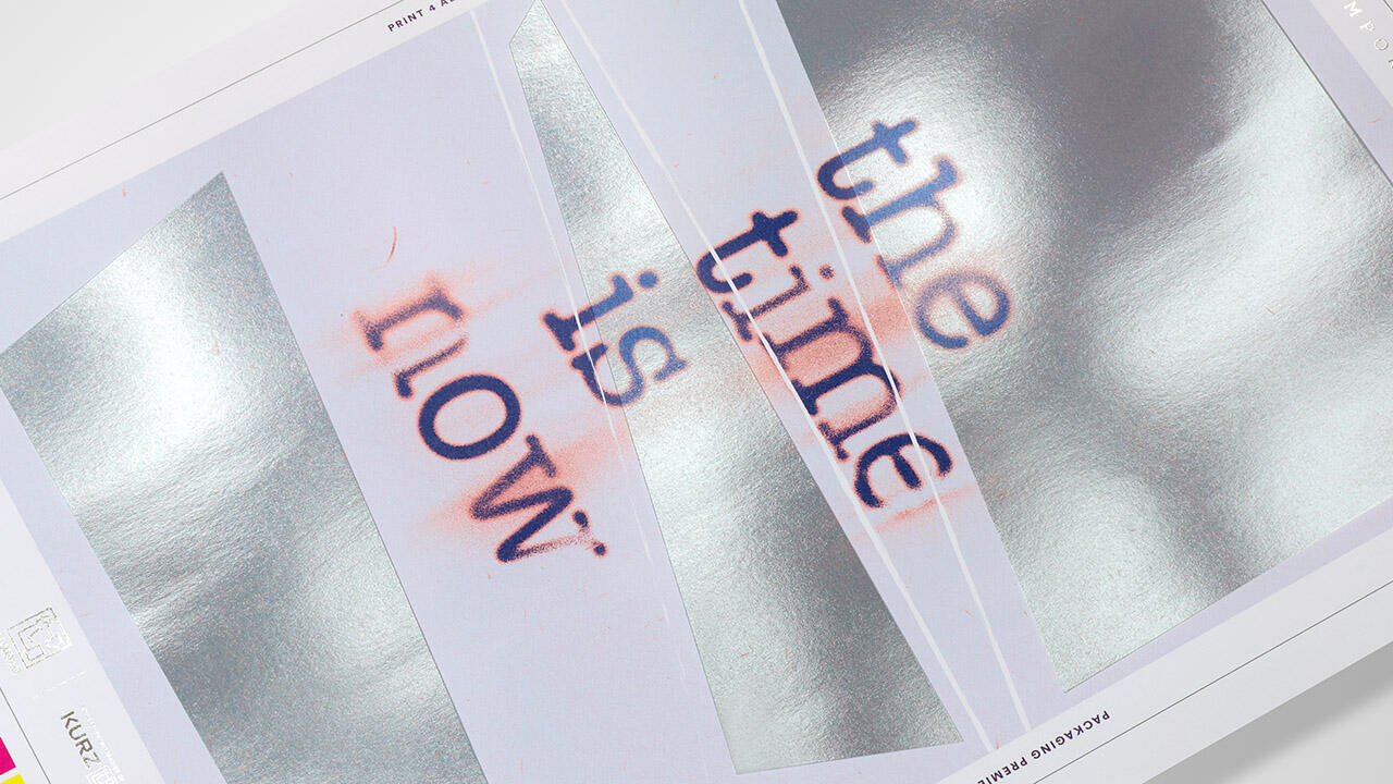 Fragmented text the time is now' on a high-gloss, metallic background, illustrating digital embellishment by the DM-SMARTLINER.